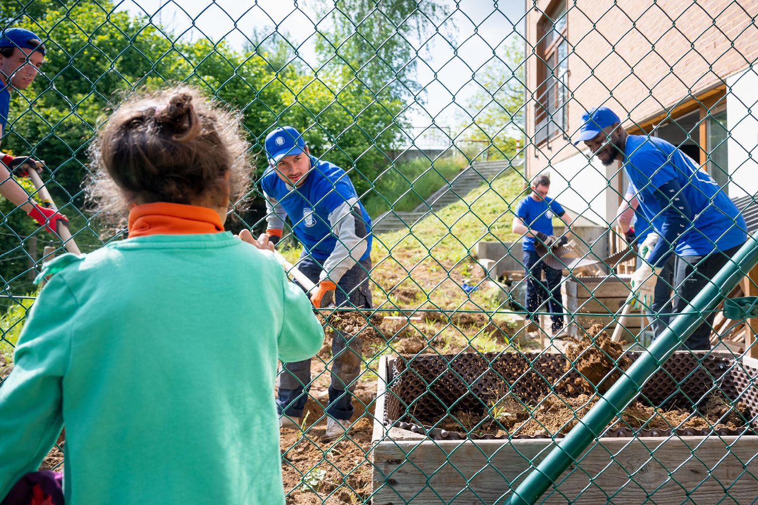 volunteers of KPMG putting soil in a container 