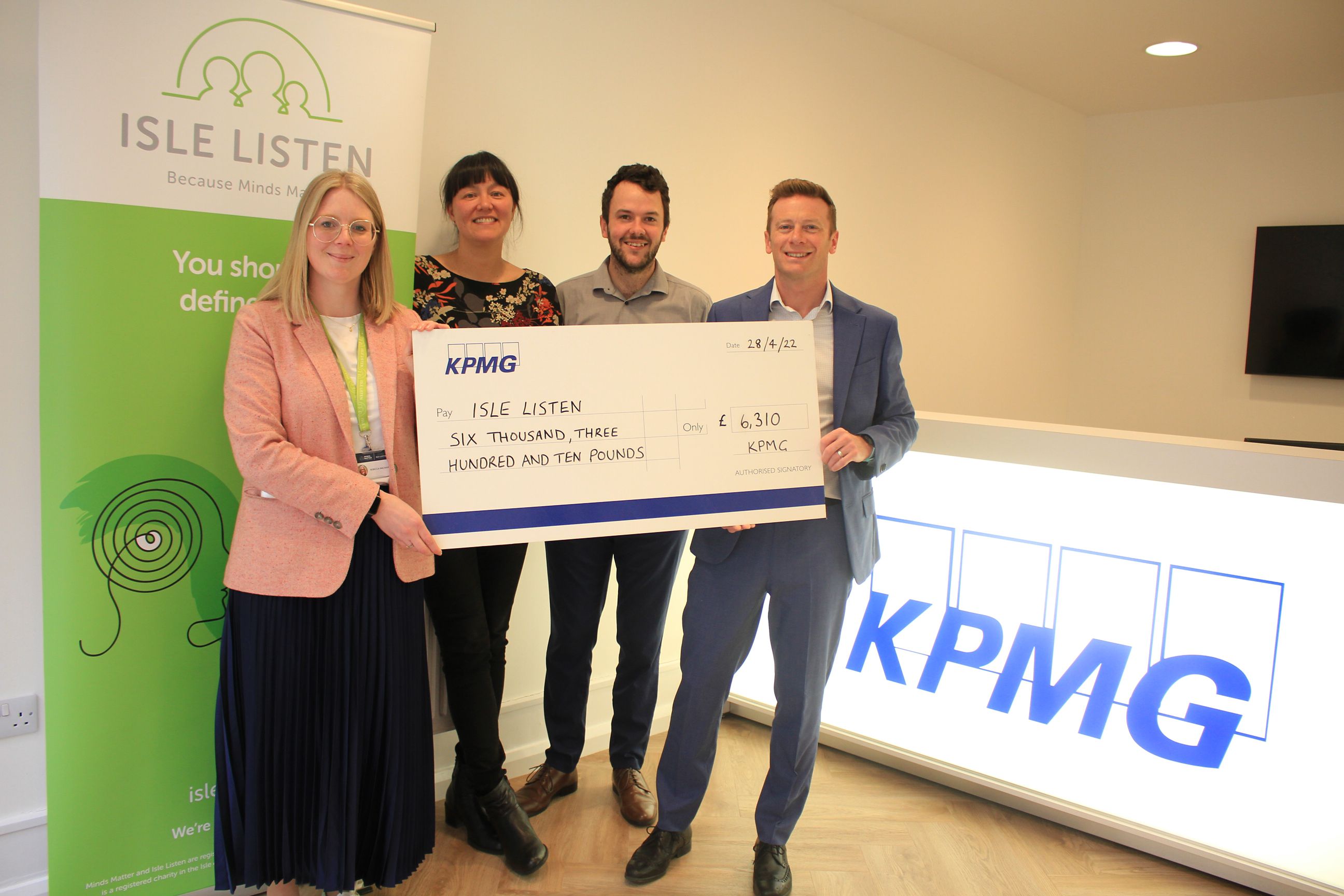 KPMG charity committee staff presenting the cheque to Isle Listen representative Rebecca Macnair