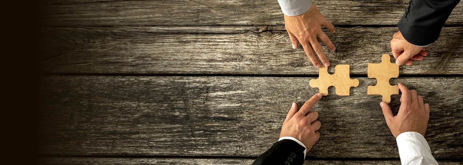 hands assembling a puzzle