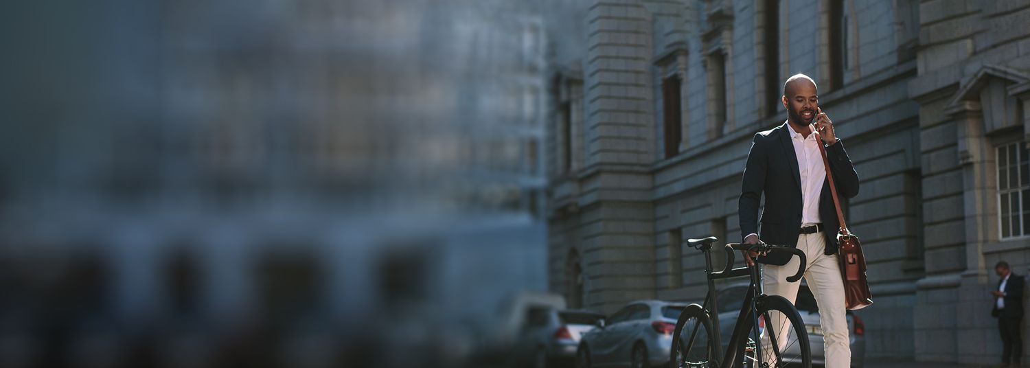 Business man with bicycle having a phone call