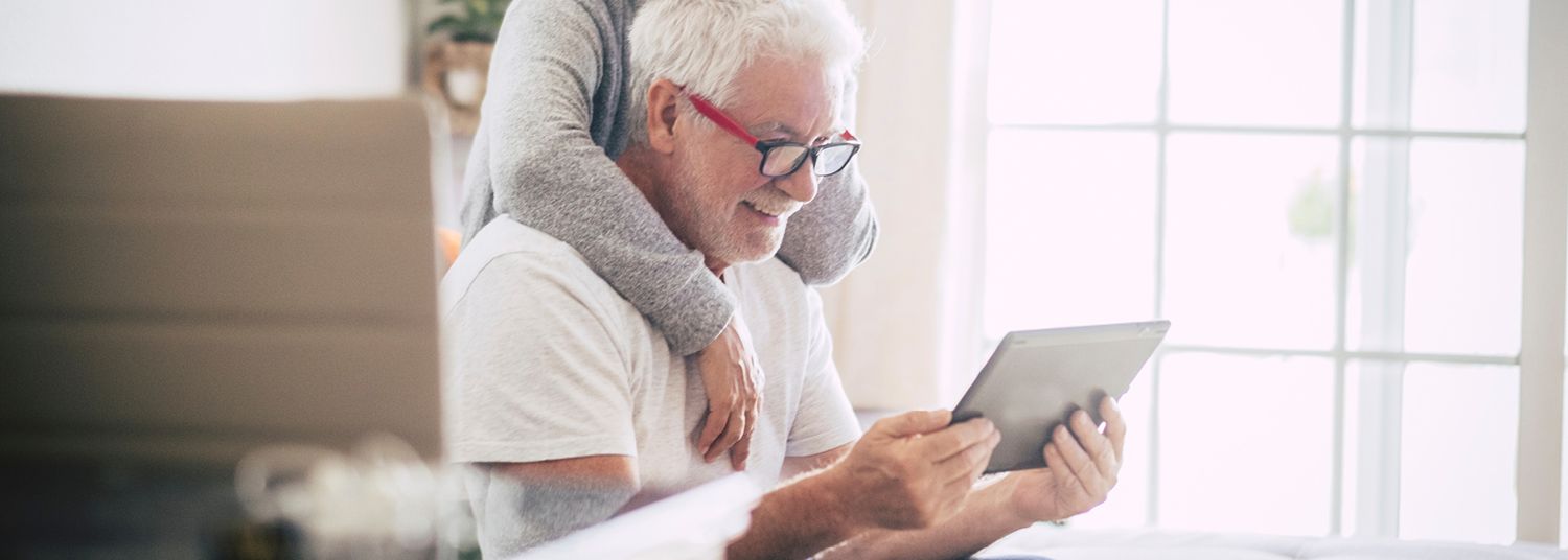 Elderly couple looking at tablet