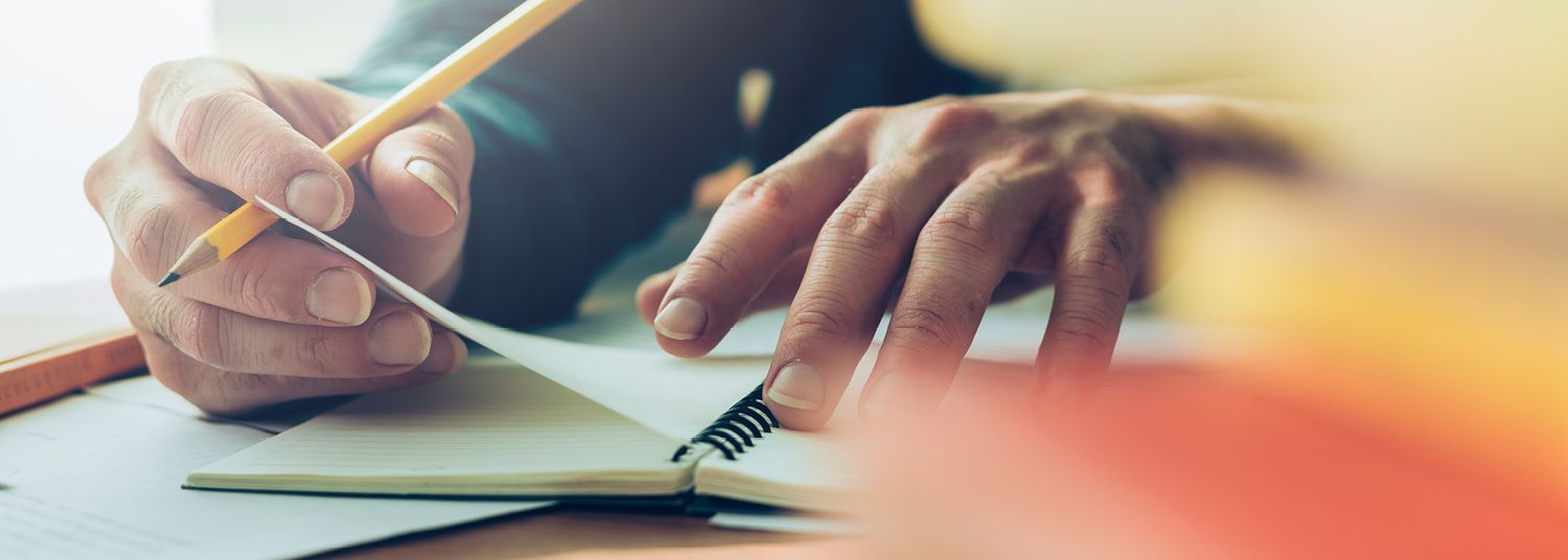 Man writing in notebook