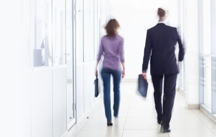 People walking in office hallway