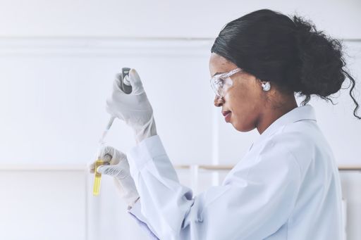 Woman scientist piping materials into test tube