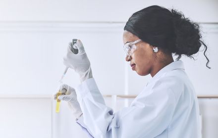 Woman scientist piping materials into test tube