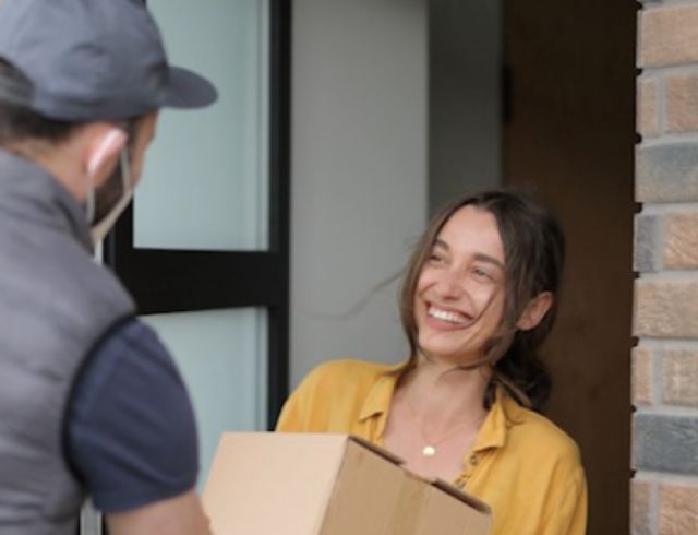 Man delivers package to happy customer