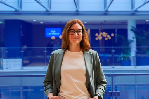 woman with glasses looking at the camera