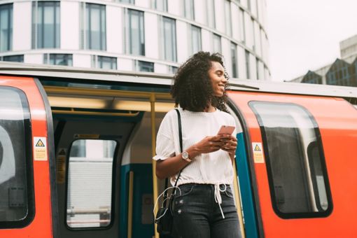 Young woman steps off metro