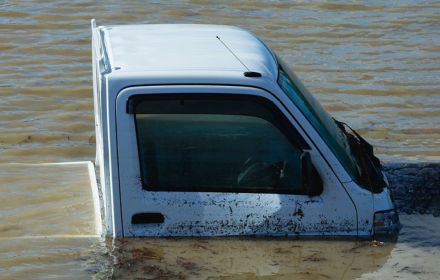 Pick-up truck under water on flooded road