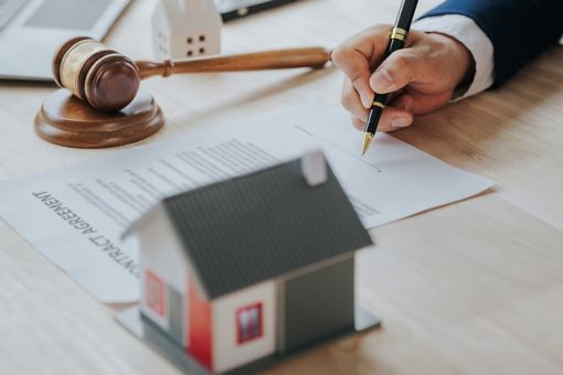 A hand getting ready to sign a document