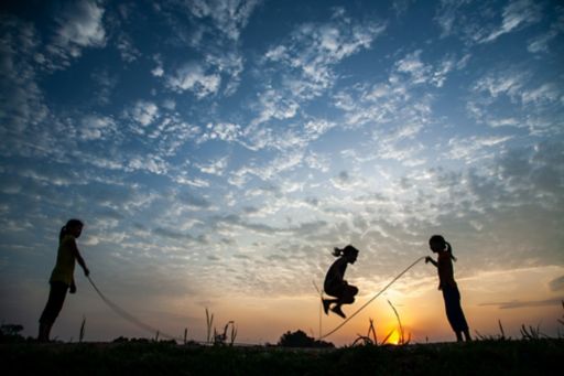 Silhouette of poeple skipping