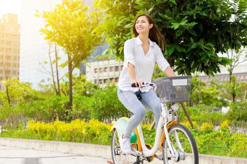 A businesswoman cycles through the city