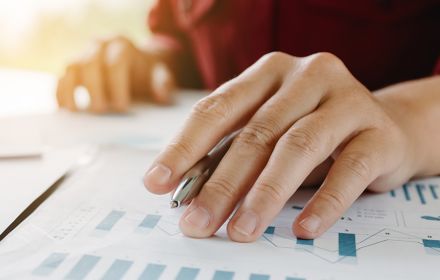 A businessperson looking at numbers in the context of reporting