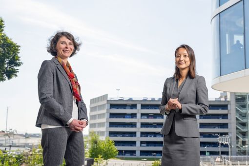 Kathy Lim and Muriel Narmon standing in front of the KPMG building