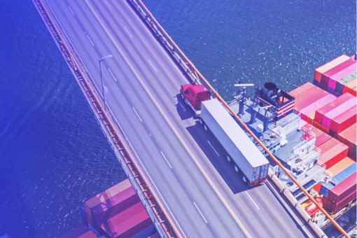 Lorry on bridge over container ship