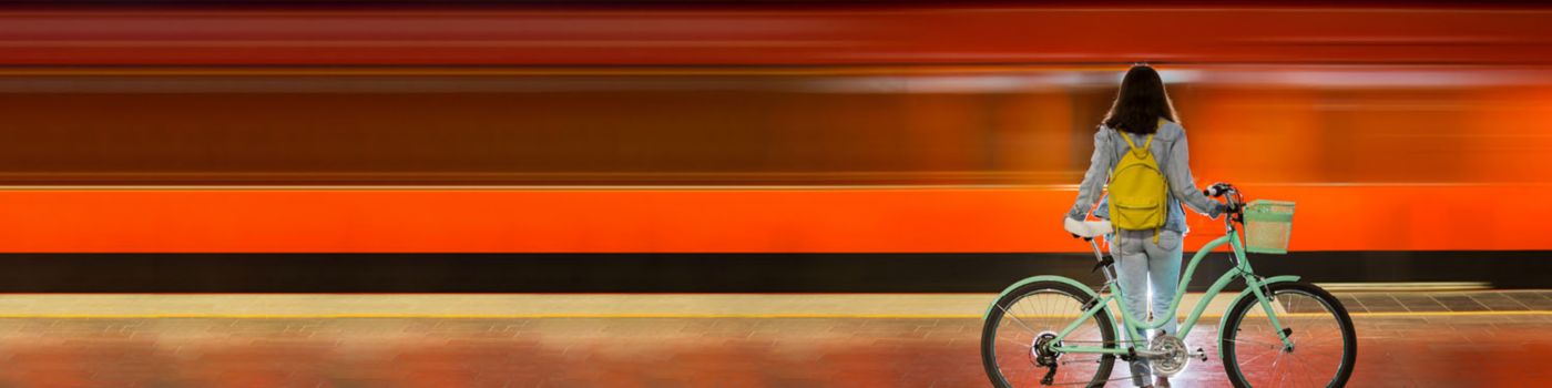 Woman with bicycle on train station platform