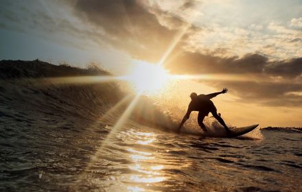 Man surfing at sunset