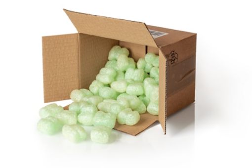 A small brown packaging box with green foam bits in it
