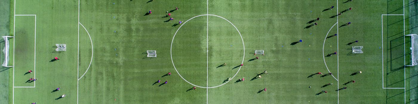 Aerial view of a soccer, football match. Football field and Footballers