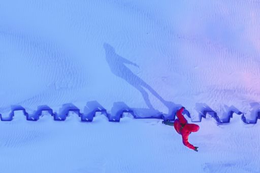 Aerial view of a person walking through snow