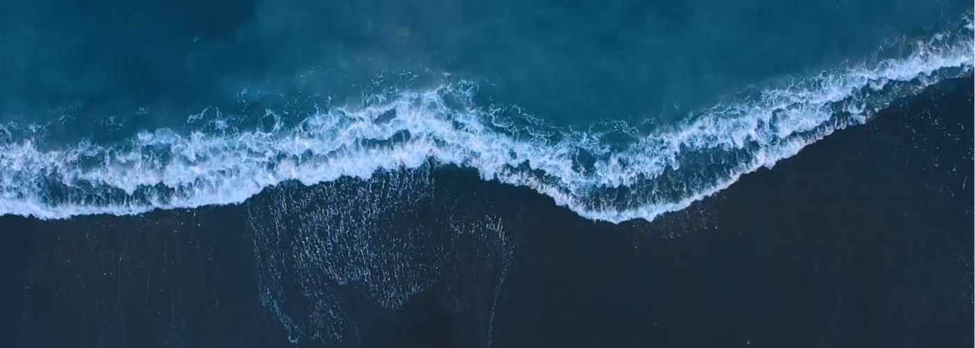 aerial view of waves reaching shore