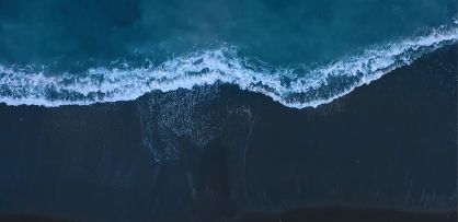 Aerial view of sea waves reaching shore