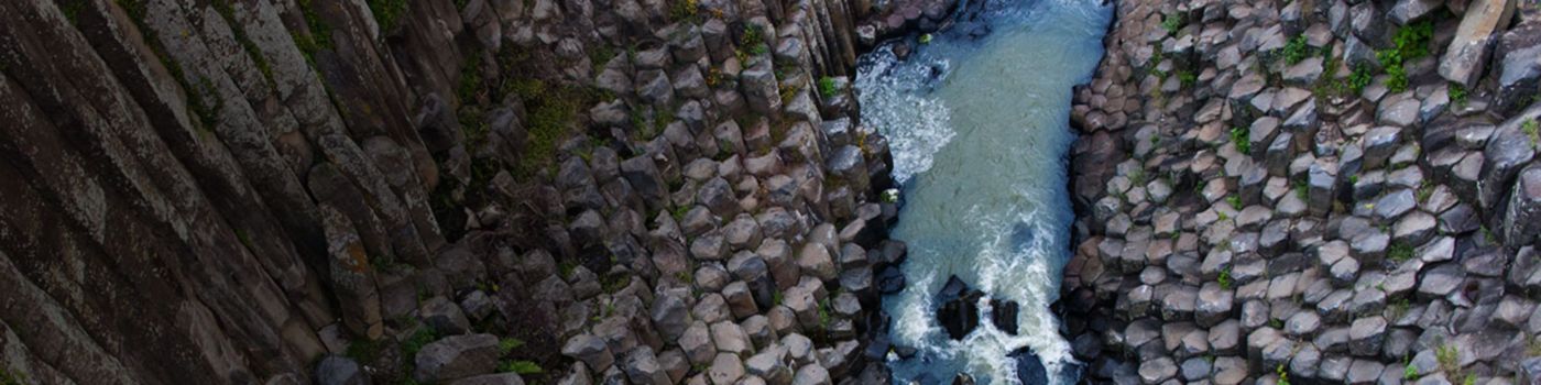 Aerial view of water flowing through stones