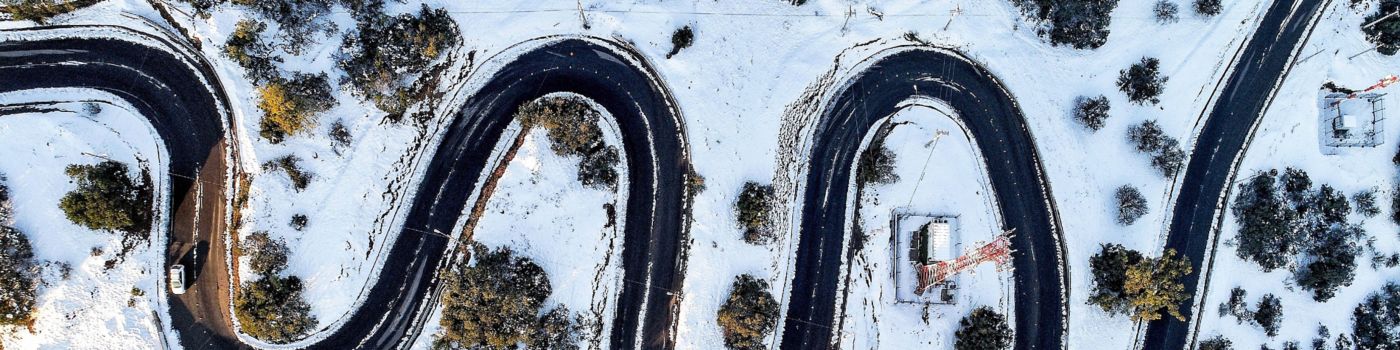Aerial view of the zigzag road over snow