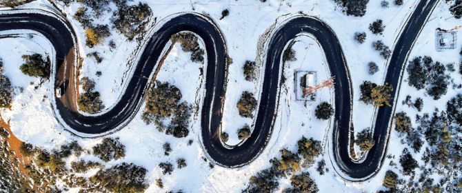 Aerial view of zigzag road over snow
