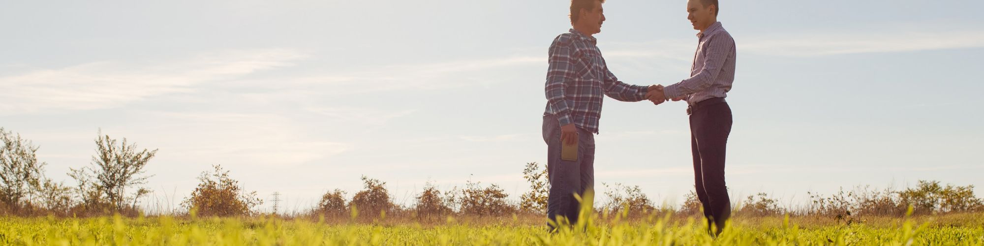 Two farmers talking on the field