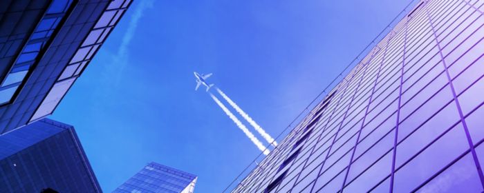 Airplane fly-over modern buildings