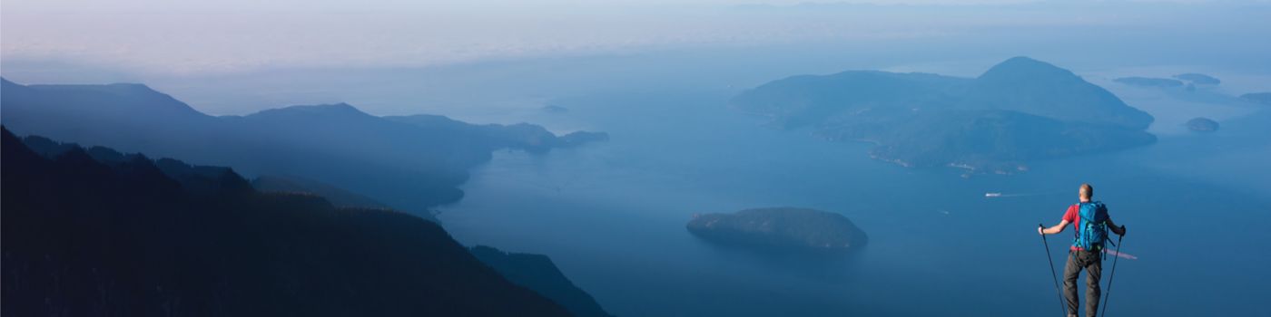 Man standing on rock looking at mountains