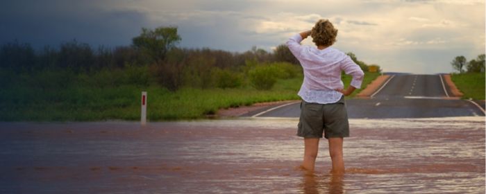 Woman standing in floodwater in the Australian outback