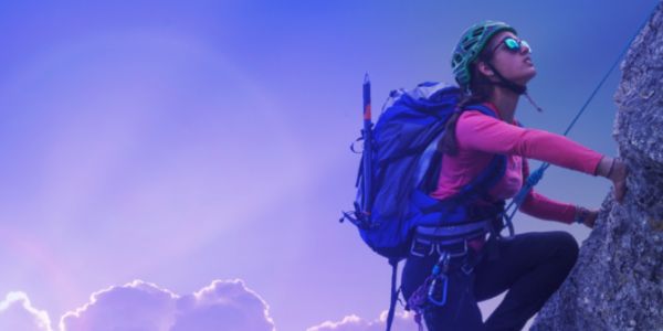 Woman climbing mountain