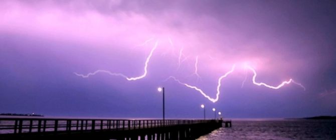 Lightning above a bridge an the ocean