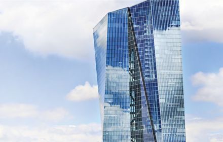 Blue tall glass building against sky