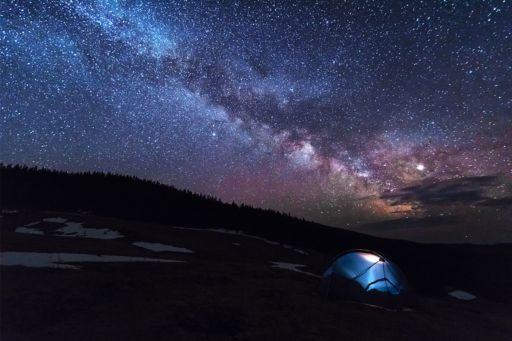 Blue tent under a night sky