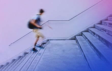 Blurred student walking up stairs