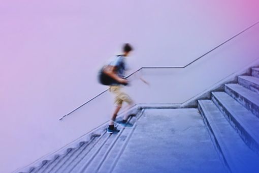 Blurred student walking up stairs