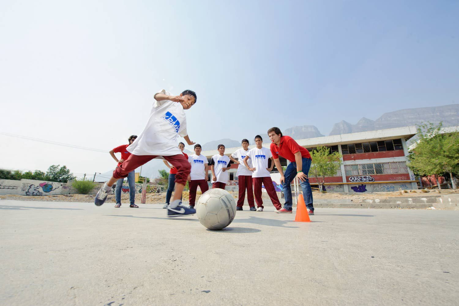 boy kicking a soccer ball