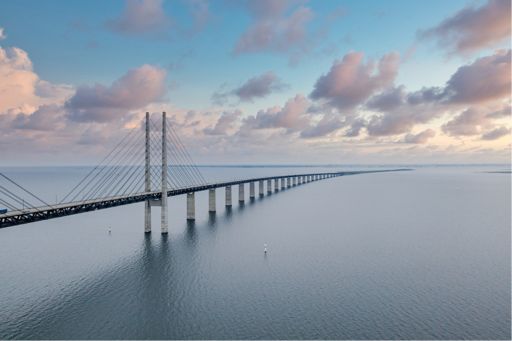 bridge over sea under clouds