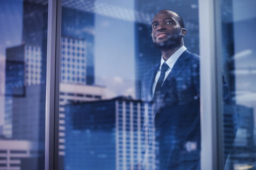 Businessman looking out of an office window