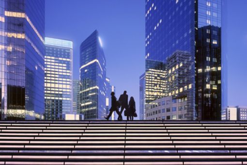 Business people on city steps at night