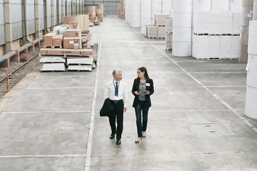 Business people walking in warehouse
