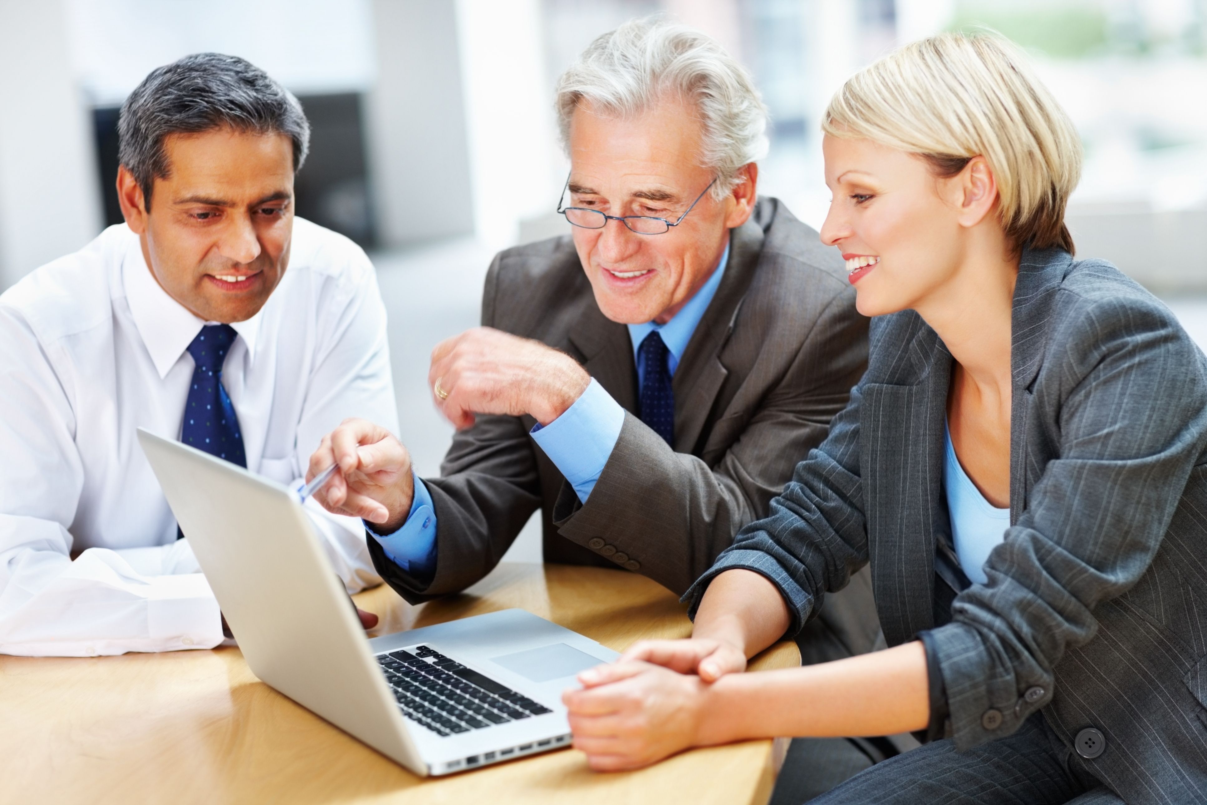Successful business people working on a laptop at meeting