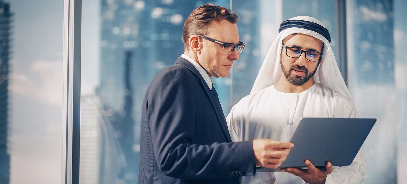 Businessmen looking at a laptop