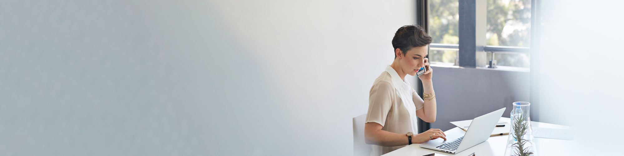 Woman taking a call during her work day to enquire about a waver of loan repayments