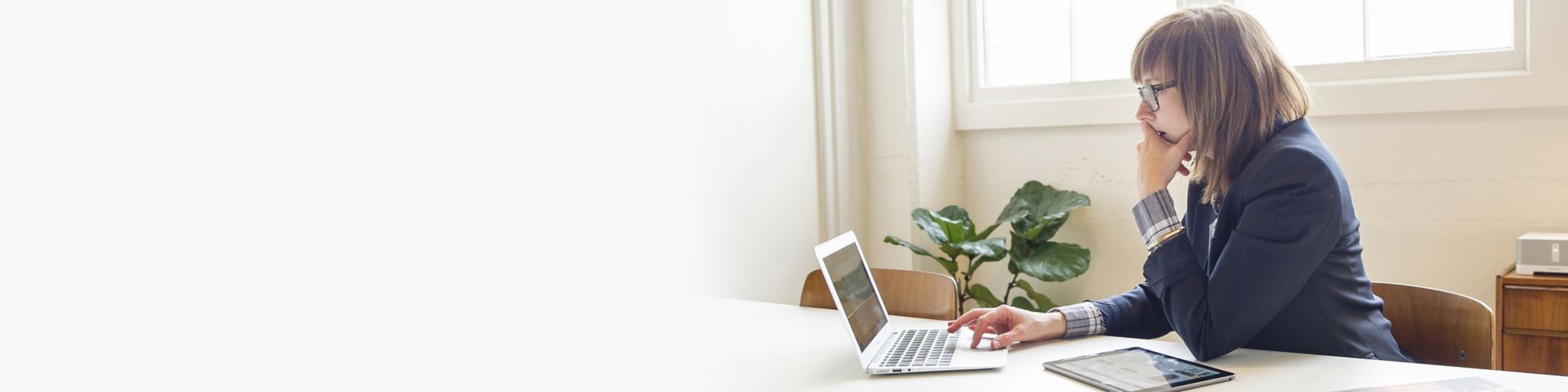 Mid-market businesswoman using laptop looking at business data