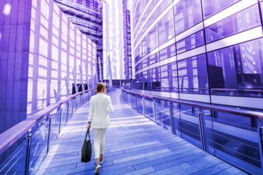 businesswoman walking with tall buildings