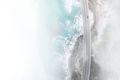Car driving along ocean